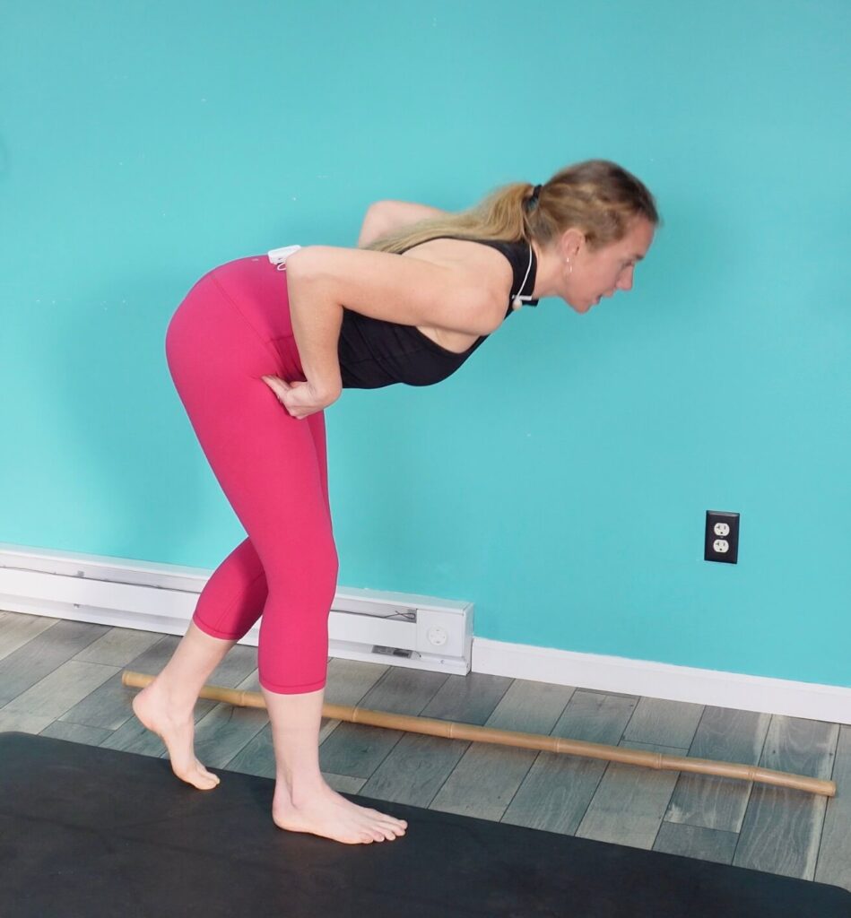 Place one foot behind the other and use your toes to balance as you hinge forward as a hip hinging exercise